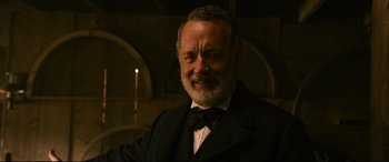 Movie still from “News of the World” (2020), directed by Paul Greengrass – An older man wearing a suit and bow tie; Close Up shot, Low angle