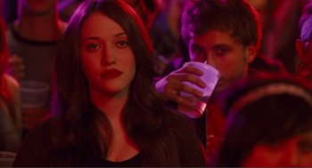Movie still from “Nick and Norah's Infinite Playlist” (2008), directed by Peter Sollett – A woman sitting next to a man holding a drink; Close Up shot, Over the shoulder angle