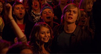 Movie still from “Nick and Norah's Infinite Playlist” (2008), directed by Peter Sollett – A group of young people in a crowd of people; Medium shot, Over the shoulder angle