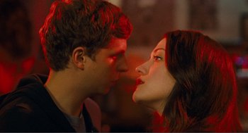 Movie still from “Nick and Norah's Infinite Playlist” (2008), directed by Peter Sollett – A man and a woman kissing in a room lit by red light; Close Up shot, Overhead angle