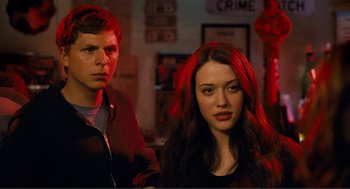 Movie still from “Nick and Norah's Infinite Playlist” (2008), directed by Peter Sollett – A man and a woman standing next to each other in a room; Close Up shot, Over the shoulder angle