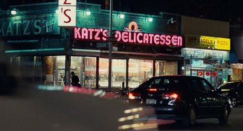 Movie still from “Nick and Norah's Infinite Playlist” (2008), directed by Peter Sollett – A car parked on the side of the road in front of katz's delicatessen; Wide shot, High angle