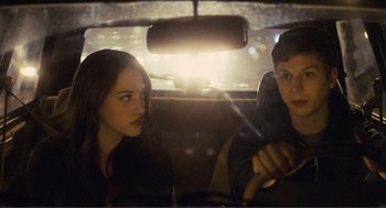 Movie still from “Nick and Norah's Infinite Playlist” (2008), directed by Peter Sollett – A woman and a man sitting in the back seat of a car; Close Up shot, Over the shoulder angle