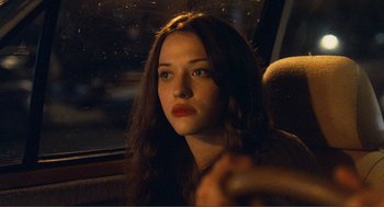 Movie still from “Nick and Norah's Infinite Playlist” (2008), directed by Peter Sollett – A woman sitting in a car looking out the window at night; Close Up shot, Over the shoulder angle