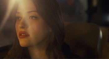 Movie still from “Nick and Norah's Infinite Playlist” (2008), directed by Peter Sollett – A young woman's face with long brown hair; Close Up shot, Over the shoulder angle