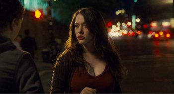 Movie still from “Nick and Norah's Infinite Playlist” (2008), directed by Peter Sollett – A beautiful young woman standing on a sidewalk at night; Medium shot, Over the shoulder angle