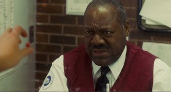 Movie still from “Nick and Norah's Infinite Playlist” (2008), directed by Peter Sollett – A man in a red vest and a white shirt; Close Up shot, Over the shoulder angle