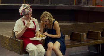 Movie still from “Nick and Norah's Infinite Playlist” (2008), directed by Peter Sollett – Two women sitting on a bench eating hot dogs; Medium shot, Over the shoulder angle