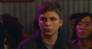 Movie still from “Nick and Norah's Infinite Playlist” (2008), directed by Peter Sollett – A young man in a leather jacket looking at the camera; Close Up shot, Over the shoulder angle