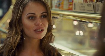 Movie still from “Nick and Norah's Infinite Playlist” (2008), directed by Peter Sollett – A beautiful young woman with long brown hair and blue eyes; Close Up shot, Over the shoulder angle