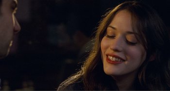 Movie still from “Nick and Norah's Infinite Playlist” (2008), directed by Peter Sollett – A person smiling with her eyes closed; Close Up shot, Over the shoulder angle