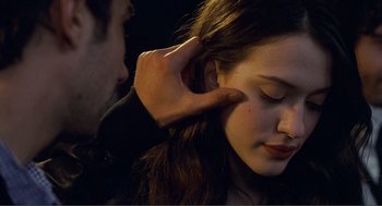 Movie still from “Nick and Norah's Infinite Playlist” (2008), directed by Peter Sollett – A man touching the ear of a young woman; Close Up shot, Over the shoulder angle