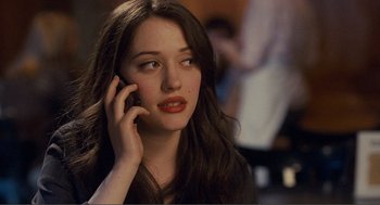 Movie still from “Nick and Norah's Infinite Playlist” (2008), directed by Peter Sollett – A woman talking on a cell phone while sitting down; Close Up shot, Over the shoulder angle