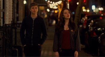 Movie still from “Nick and Norah's Infinite Playlist” (2008), directed by Peter Sollett – Two people standing on a sidewalk at night; Medium shot, Over the shoulder angle