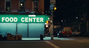 Movie still from “Nick and Norah's Infinite Playlist” (2008), directed by Peter Sollett – A street corner with a building and a traffic light at night time; Extreme Wide shot, High angle