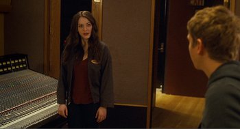 Movie still from “Nick and Norah's Infinite Playlist” (2008), directed by Peter Sollett – A woman standing in front of a door; Medium shot, Over the shoulder angle