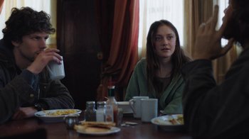 Movie still from “Night Moves” (2013), directed by Kelly Reichardt – A woman sitting at a table with food; Medium shot, Over the shoulder angle