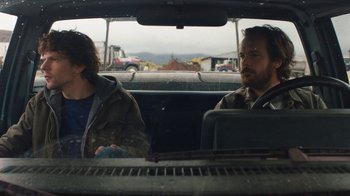 Movie still from “Night Moves” (2013), directed by Kelly Reichardt – Two men sitting in the back seat of a car; Medium shot, Over the shoulder angle