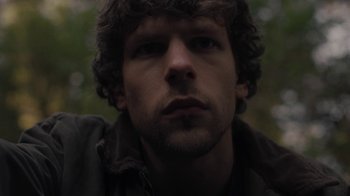 Movie still from “Night Moves” (2013), directed by Kelly Reichardt – A man's face in a forest; Close Up shot, Low angle