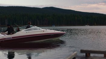 Movie still from “Night Moves” (2013), directed by Kelly Reichardt – A man is sitting on the back of a boat in the water; Extreme Wide shot, High angle