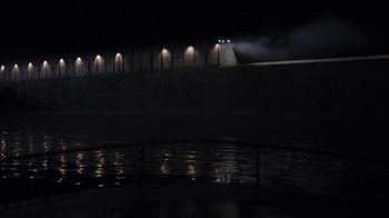 Movie still from “Night Moves” (2013), directed by Kelly Reichardt – A body of water at night with lights on; Extreme Wide shot, High angle