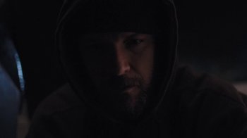 Movie still from “Night Moves” (2013), directed by Kelly Reichardt – A person wearing a hooded sweatshirt; Close Up shot, Low angle