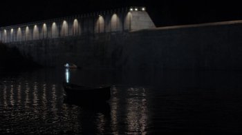 Movie still from “Night Moves” (2013), directed by Kelly Reichardt – A small boat in the water at night; Extreme Wide shot, High angle