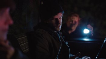 Movie still from “Night Moves” (2013), directed by Kelly Reichardt – A man sitting in front of another man in a dark room; Close Up shot, Over the shoulder angle