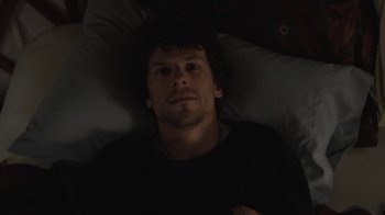 Movie still from “Night Moves” (2013), directed by Kelly Reichardt – A man laying in a bed looking up at the camera; Close Up shot, Overhead angle