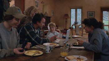 Movie still from “Night Moves” (2013), directed by Kelly Reichardt – A group of people sitting at a table with a laptop computer; Medium shot, Low angle