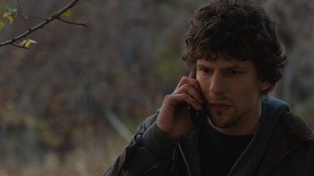 Movie still from “Night Moves” (2013), directed by Kelly Reichardt – A man with curly hair talking on a cell phone; Close Up shot, Over the shoulder angle