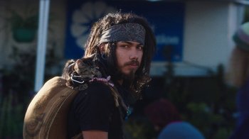 Movie still from “Night Moves” (2013), directed by Kelly Reichardt – A man with dreadlocks holding a cat on his shoulder; Close Up shot, Low angle