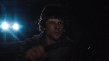 Movie still from “Night Moves” (2013), directed by Kelly Reichardt – A man with long dark hair is holding a steering wheel; Close Up shot, Over the shoulder angle