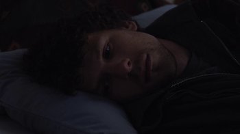 Movie still from “Night Moves” (2013), directed by Kelly Reichardt – A person laying in a bed; Close Up shot, Overhead angle
