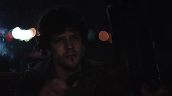Movie still from “Night Moves” (2013), directed by Kelly Reichardt – A man with a beard is sitting in a car at night; Close Up shot, Over the shoulder angle