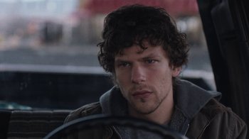 Movie still from “Night Moves” (2013), directed by Kelly Reichardt – A person sitting in a car holding a steering wheel; Close Up shot, Over the shoulder angle