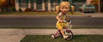 Movie still from “Monster House” (2006), directed by Gil Kenan – A little girl riding a tricycle down a street; Medium shot, High angle