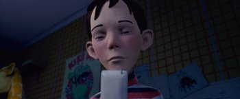 Movie still from “Monster House” (2006), directed by Gil Kenan – A boy with his eyes closed is holding a cell phone; Close Up shot, Low angle