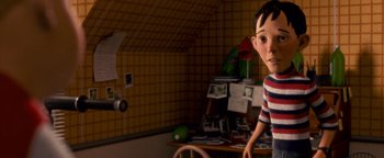 Movie still from “Monster House” (2006), directed by Gil Kenan – A boy is standing next to a table in a room; Medium shot, High angle
