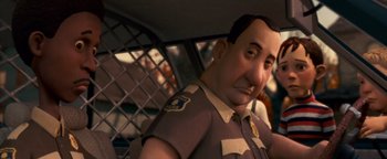 Movie still from “Monster House” (2006), directed by Gil Kenan – A man in a police uniform in a car; Close Up shot, Over the shoulder angle