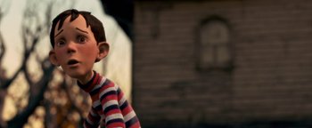 Movie still from “Monster House” (2006), directed by Gil Kenan – A young boy wearing a striped shirt is smiling for the camera; Close Up shot, Low angle