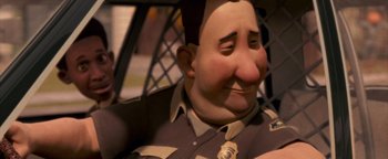 Movie still from “Monster House” (2006), directed by Gil Kenan – An animated character with a police badge on his chest; Close Up shot, Low angle