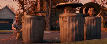 Movie still from “Monster House” (2006), directed by Gil Kenan – Two trash cans and a doll head in it; Wide shot, Low angle