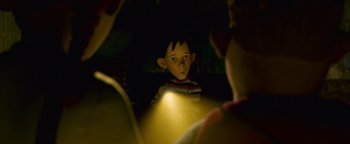 Movie still from “Monster House” (2006), directed by Gil Kenan – A boy with a light shining on him; Close Up shot, Over the shoulder angle