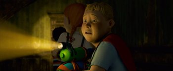 Movie still from “Monster House” (2006), directed by Gil Kenan – A boy with blonde hair is holding a green toy train; Close Up shot, High angle
