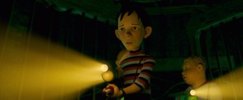 Movie still from “Monster House” (2006), directed by Gil Kenan – A boy is holding a flashlight in his hand; Medium shot, Low angle