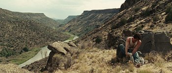 Movie still from “No Country for Old Men” (2007), directed by Joel Coen – A view of a valley with a river in the distance; Extreme Wide shot, High angle