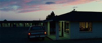 Movie still from “No Country for Old Men” (2007), directed by Joel Coen – A truck parked in front of a motel room; Extreme Wide shot, Low angle