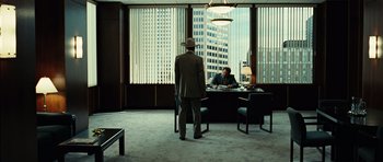 Movie still from “No Country for Old Men” (2007), directed by Joel Coen – A man standing in front of a window in a room; Wide shot, Low angle