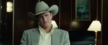 Movie still from “No Country for Old Men” (2007), directed by Joel Coen – A man wearing a cowboy hat and a suit; Close Up shot, Over the shoulder angle